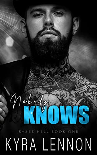 Cover for Nobody Knows featuring a handsome tattooed man with a beard under a spotlight.