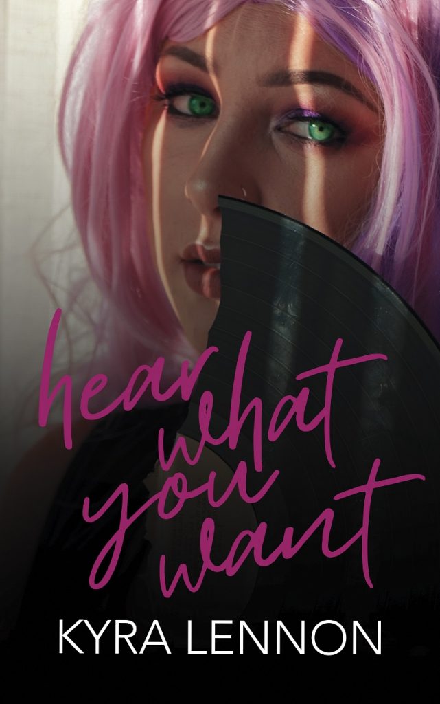 Cover of Hear What You Want featuring a young girl with bright green eyes and pink and purple hair, holding a broken record by her face. 